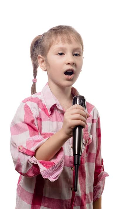 Little Cute Girl Singing Into A Microphone On A White Background Stock