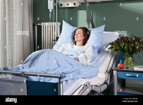 A Woman Lying In A Hospital Bed Stock Photo Alamy