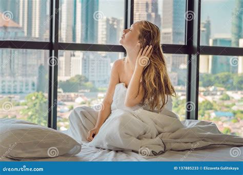 Woman Wakes Up In The Morning In An Apartment In The Downtown Area With A View Of The
