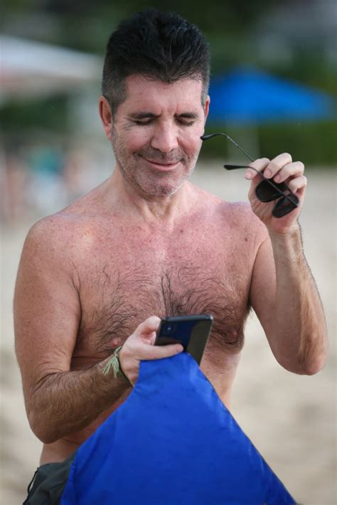 simon cowell spotted with black eye and fit physique while on vacation