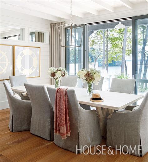 the dining room table is surrounded by gray chairs and white walls with