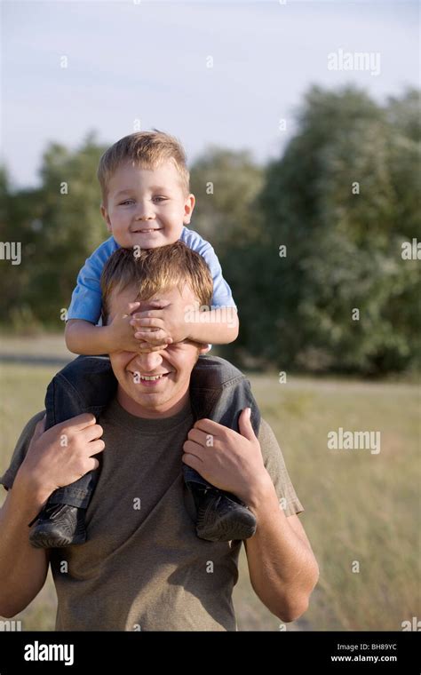 A Man Carrying A Boy On His Shoulders Stock Photo Alamy