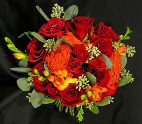 Vibrant wedding bouquet at ebell long beach in california. Red rose, orange freesia and orange yarrow bouquet ...