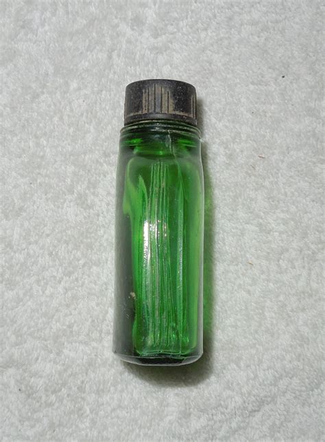 Small Green Glass Bottle Includes Screw On Lid With Glass Stirrer Needs To Be Cleaned