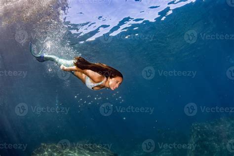 Mermaid Swimming Underwater In The Deep Blue Sea 17367173 Stock Photo