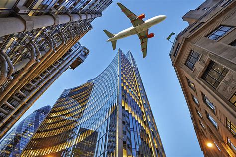 A Jet Plane Flying Over The City Photograph By Bombaert Patrick Pixels