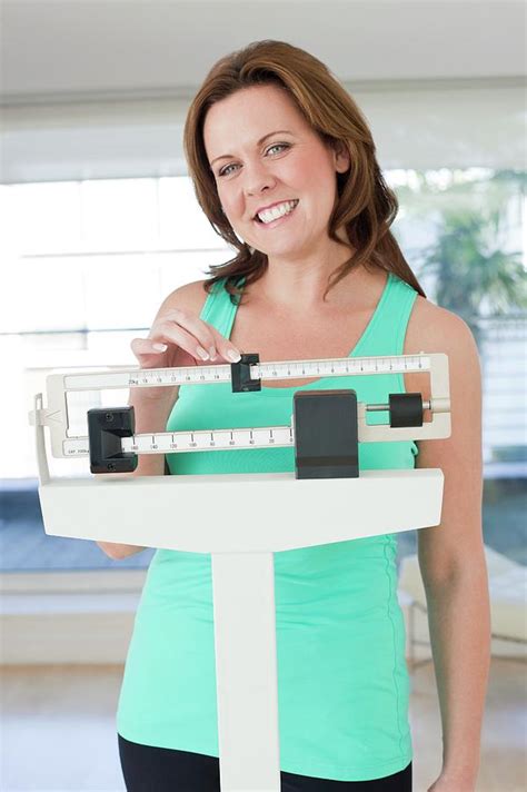 Woman Weighing Herself Photograph By Ian Hooton Science Photo Library