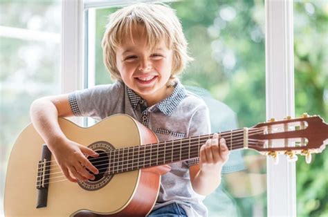 Boy-playing-guitar | Oksana Management Group, Inc.
