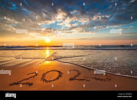 Happy New Year 2023 Text On The Beach Sand During Scenic Morning