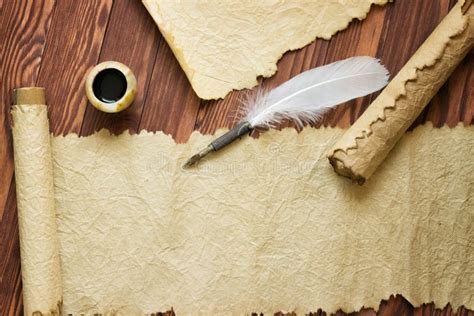 Old Paper Scroll And Quill Pen On Wooden Paper With Copy Space Stock
