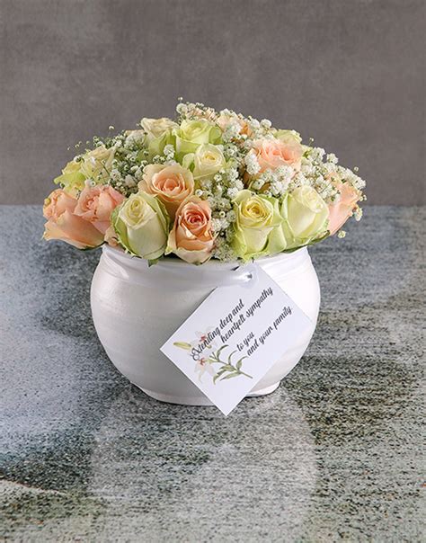 mixed sympathy roses in white ceramic vase hamperlicious