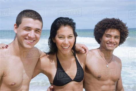 Multi Ethnic Friends Hugging On Beach Stock Photo Dissolve