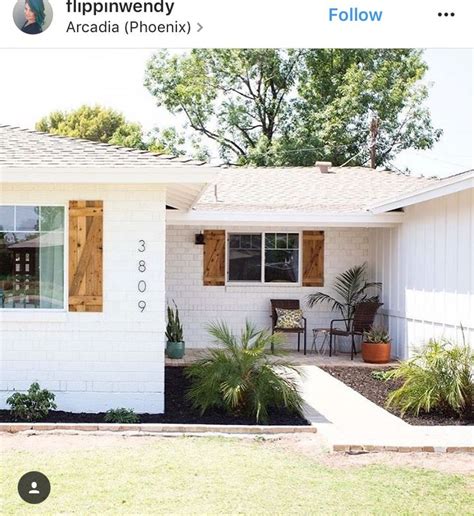 Looks like there might be even a speaker built into the fireplace. White painted brick + wood shutters | White exterior ...