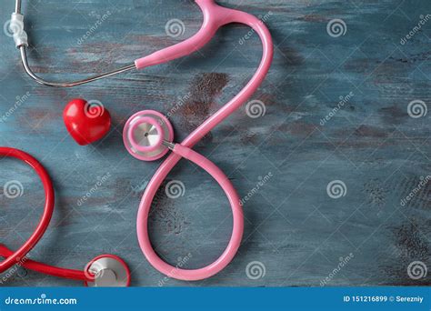 Medical Stethoscopes And Red Heart On Wooden Background Cardiology