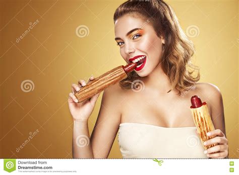 Young Woman Eating A Hot Dog Royalty Free Stock