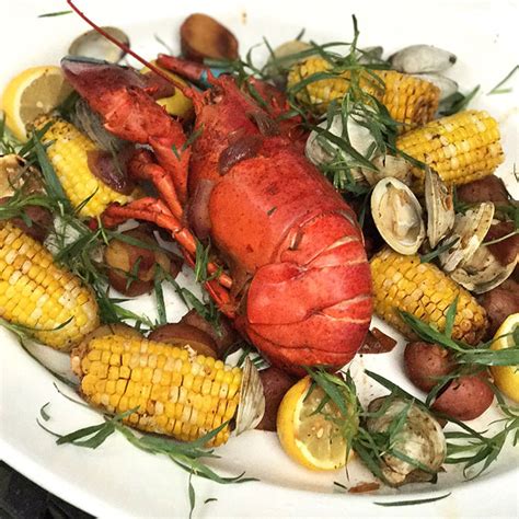 Once you remove your chicken, add the corn and seafood boil on top. Easy and Delicious New England Clambake Recipe ...