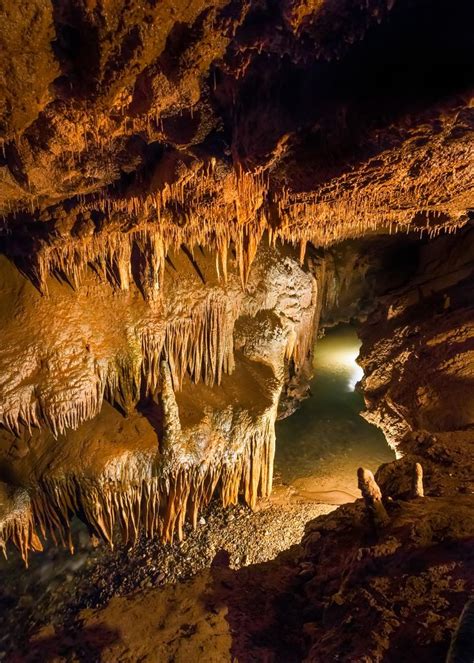 Subterranean Cavern A Stream Flows Beneath Delicate Rock
