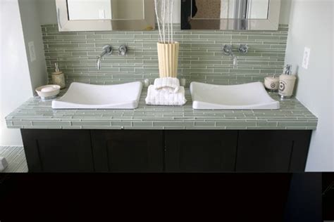 The tiles are cracking and breaking on your bathroom countertops, so it's time to replace them. Is glass tile suitable for use in a bathroom countertop ...