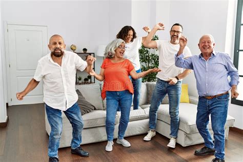 Group Of Middle Age Friends Having Party Dancing At Home Stock Image