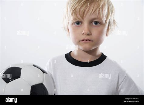 Boy In Soccer Jersey Holding Ball Stock Photo Alamy