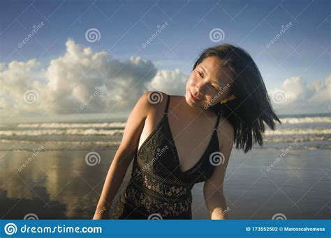 Natural Lifestyle Portrait Of Young Attractive And Happy Asian Chinese Woman In Swimsuit Walking