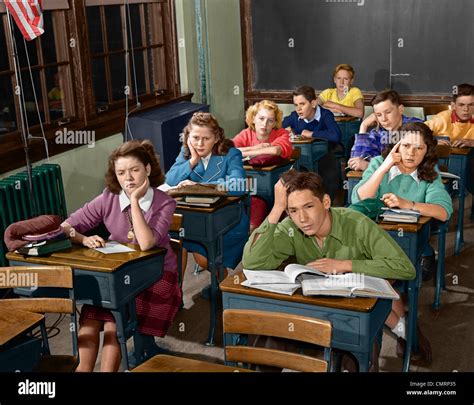 1950s High School Classroom Of Bored Sleepy Students Sitting At Desks