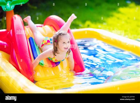 Children Playing In Inflatable Baby Pool Kids Swim And Splash In Stock