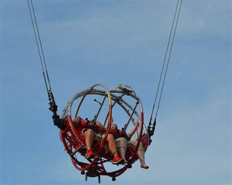 Young couples riding the slingshot ride. What You Need To Know About The Slingshot Ride