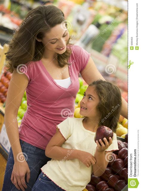 Mother And Daughter Shopping In Produce Section Stock