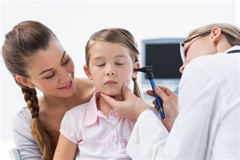 Girl Being Examined By Doctor With Otoscope Stock Photo Image Of
