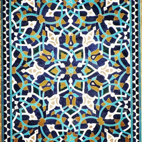 An Intricately Designed Carpet With Blue And Gold Colors
