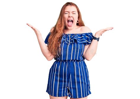 Young Beautiful Redhead Woman Wearing Casual Clothes Celebrating Mad And Crazy For Success With