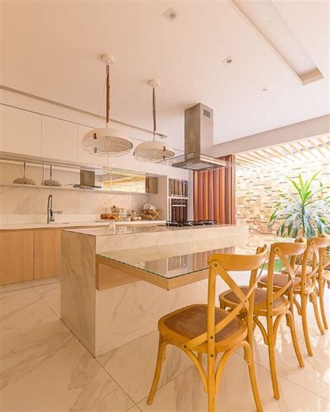 A Kitchen With Marble Counter Tops And Yellow Chairs