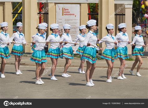 Band Majorettes Perform Various Dancing Skills On City Park Stock