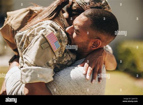 Heartwarming Military Homecoming Female Soldier Embracing Her Husband After Returning Home From