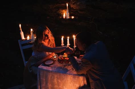 Romantic Couple Holding Hands Together Over Candlelight During R Premium Photo