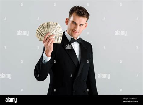Happy And Rich Man In Suit Holding Dollar Banknotes Isolated On Grey