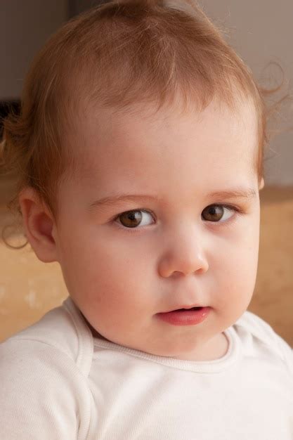 Premium Photo Portrait Of A Blond Baby Looking At Camera