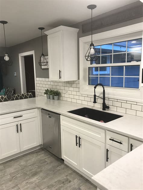 white shaker cabinets with solid surface countertops and flat black handles in 2022 white