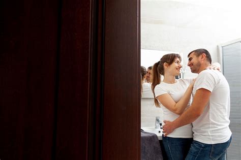 Free Photo Back View Couple Embracing And Kissing In Bathroom