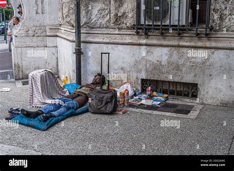 rome italy uk 28 august 2021 a homeless man sleeps half naked in a residential district of