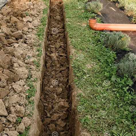A Hand Dug Trench In Field Of Flowers To Drain Groundwater Stock Image