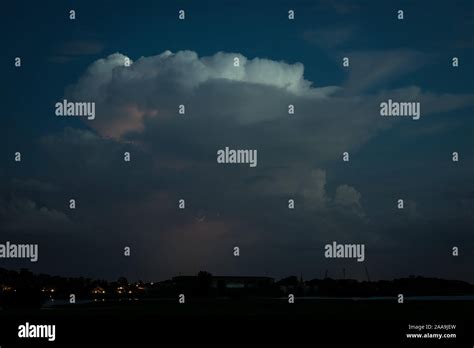 An Isolated Storm Cloud Cumulonimbus Is Illuminated By Lightning