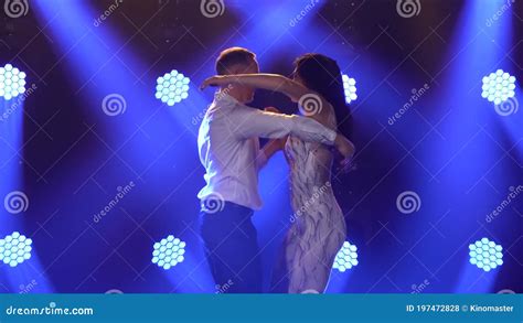 Flexible And Sensual Dancers Dance Ballroom Dancing In A Dark Hall With Blue Spotlights In The