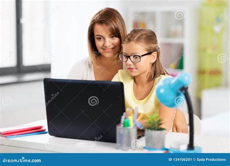 Mother And Daughter With Laptop Doing Homework Stock Image Image Of Home Generation 134106201