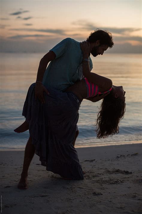 Couple Dancing At The Beach At Sunset By Stocksy Contributor Mosuno Stocksy