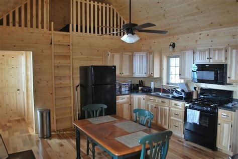 A Kitchen And Dining Area In A Log Cabin