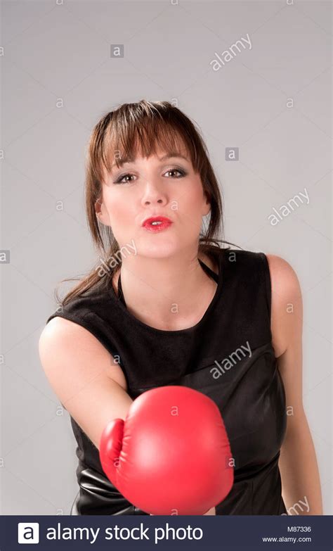 Woman Wearing A Black Leather Dress And Red Boxing Gloves