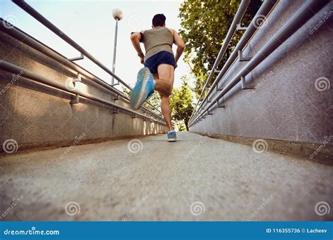 A Male Runner Runs Along The Road To The Park Stock Photo Image Of