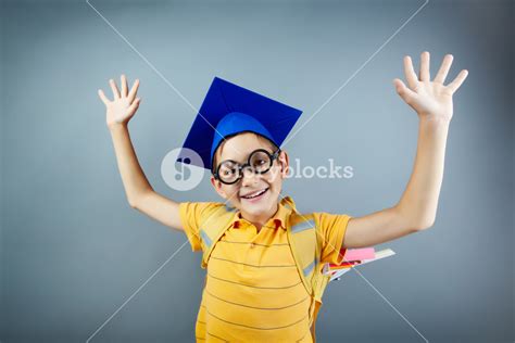 Portrait Of Happy Schoolkid With Backpack Raising Arms Royalty Free